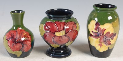 Lot 143 - A group of three small Moorcroft Pottery vases,...