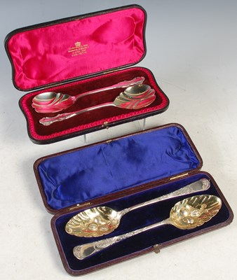 Lot 133 - A cased pair of London silver serving spoons;...