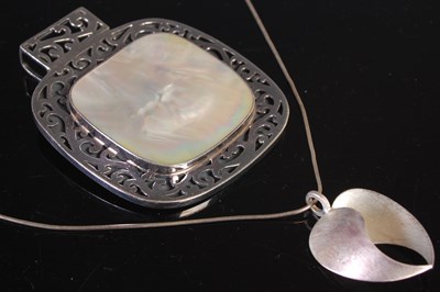 Lot 156 - Tezer, a brushed silver heart shaped pendant...