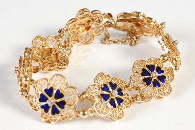 Lot 203 - A yellow metal, blue enamel and diamond set...