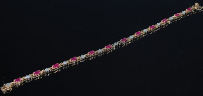Lot 206 - A 9ct gold, garnet and diamond chip bracelet,...