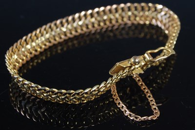 Lot 217 - A yellow metal articulated bracelet, tests as...