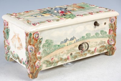 Lot 327 - A ceramic music box, decorated in relief with...
