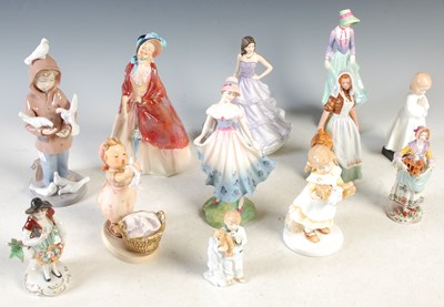 Lot 349 - A collection of twelve ceramic figure groups...