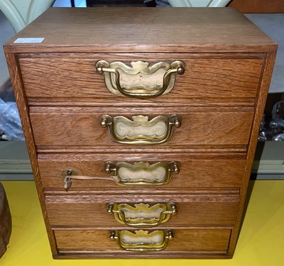 Lot 397 - A blonde oak tabletop filing chest of five...