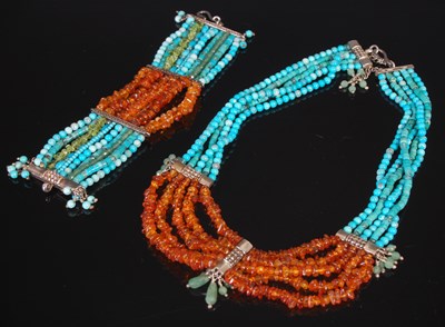 Lot 240 - A silver mounted amber and turquoise bead...