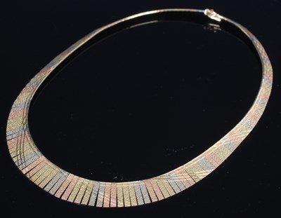 Lot 245 - A three colour yellow metal fringe necklace,...