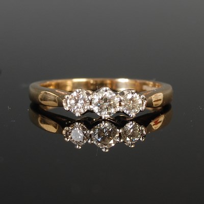 Lot 250 - An 18ct gold and diamond three stone ring,...