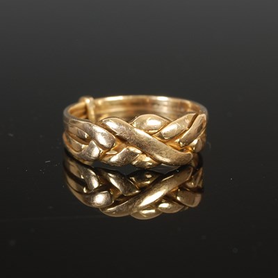 Lot 253 - A 9ct gold puzzle ring, size R 1/2, 4.2 grams.
