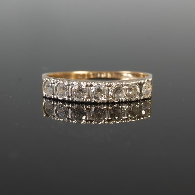 Lot 255 - A 9ct gold and diamond seven stone half-hoop...
