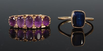 Lot 257 - A 9ct gold and purple gem stone set five stone...