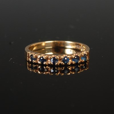 Lot 258 - A yellow metal and sapphire six stone...