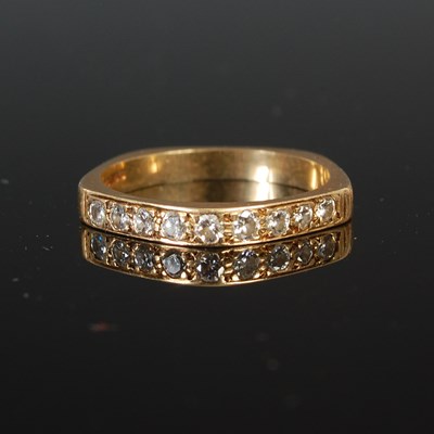 Lot 260 - An 18ct gold and diamond nine stone half-hoop...