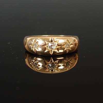 Lot 266 - An 18ct gold and diamond three stone ring,...