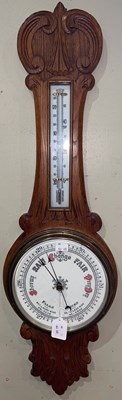 Lot 589 - An oak wall barometer, 82cm long.