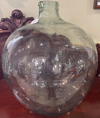 Lot 599 - A green tinted carboy glass jar, 51cm high.