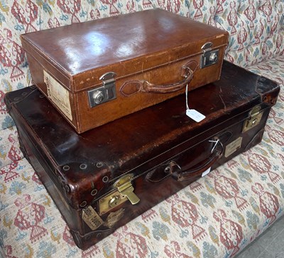 Lot 652 - An antique leather and brass mounted suitcase,...