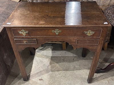 Lot 675 - A George III oak lowboy, the rectangular top...