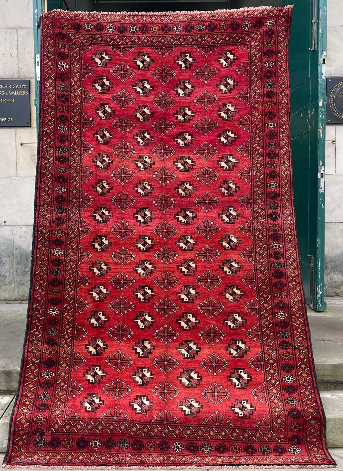 Lot 745 - A Persian Turkaman rug, the madder ground