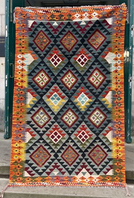 Lot 737 - A Maimana Kilim rug, the rectangular black and...