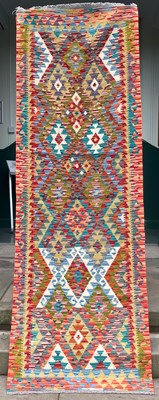 Lot 734 - A Chobi Kilim runner, the ochre/green ground...