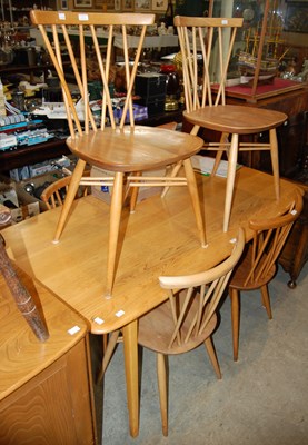 Lot 626 - A vintage blonde wood Ercol dining room suite...