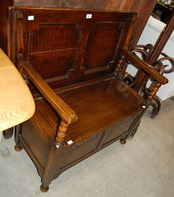 Lot 629 - An early 20th century stained oak monks bench...