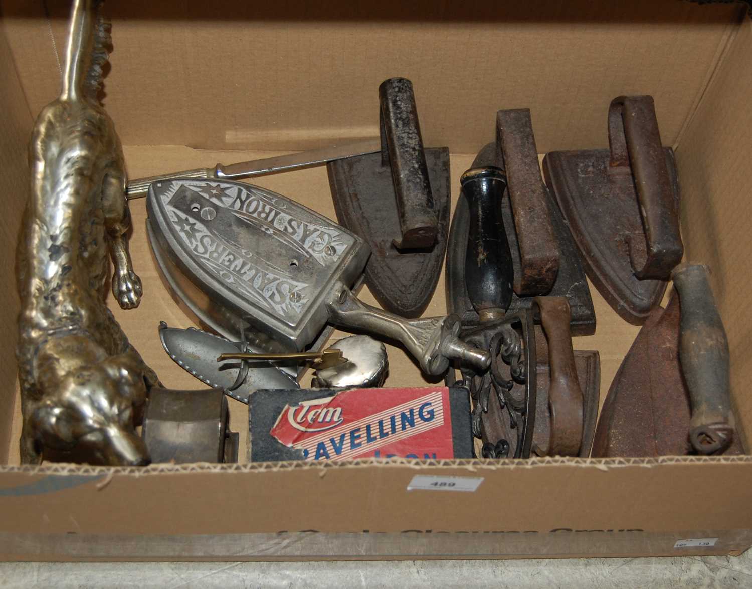 Lot 489 - Box - vintage irons and a dog form table
