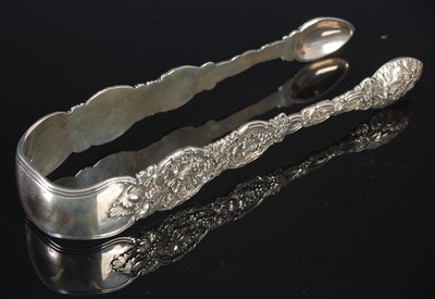 Lot 93 - An unusual pair of cast silver sugar tongs by...