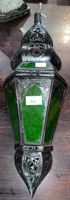 Lot 641 - An Eastern black painted metal and green glass...