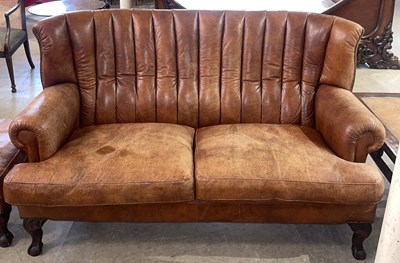 Lot 865 - A modern two-seater tan leather and brass...