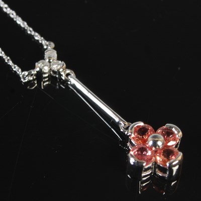 Lot 282 - An 18ct white gold necklace suspending white...