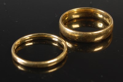 Lot 297 - Two 18ct gold wedding rings, 5.6 grams, the...