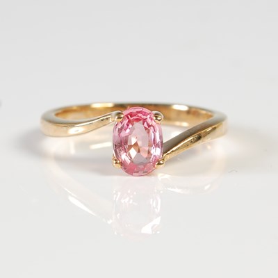 Lot 311 - An 18ct gold and pink sapphire single stone...