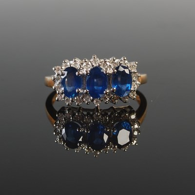 Lot 317 - An 18ct gold, sapphire and diamond dress ring,...