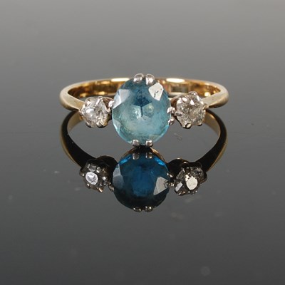 Lot 318 - A yellow metal three stone dress ring, centred...