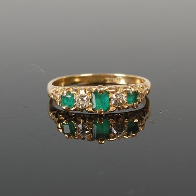 Lot 319 - A yellow metal, emerald and diamond five stone...