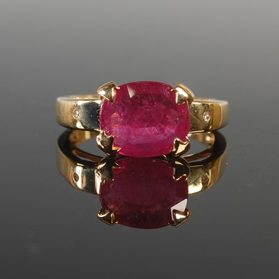 Lot 323 - An 18ct gold, ruby and diamond ring, centred...
