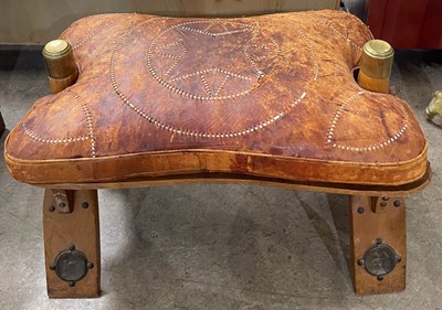 Lot 887 - A vintage camel saddle stool/ footstool with...