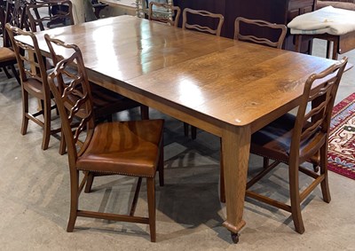Lot 890 - An early 20th century oak extending dining...