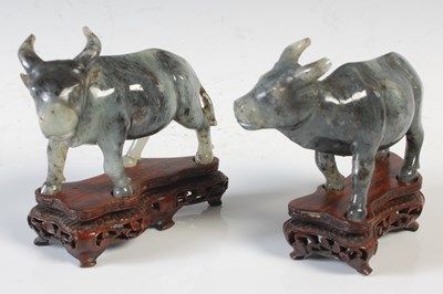 Lot 389 - A pair of Chinese green stone figures of ox,...