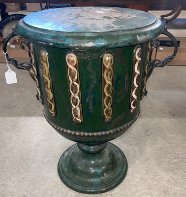 Lot 853 - A metal urn, hand painted in distressed green...