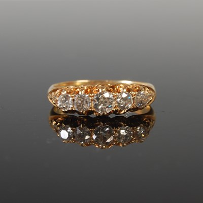 Lot 335 - An 18ct gold and diamond five stone ring,...
