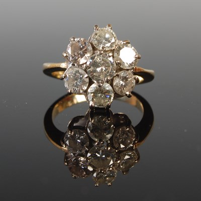Lot 336 - A white and yellow metal diamond cluster ring,...