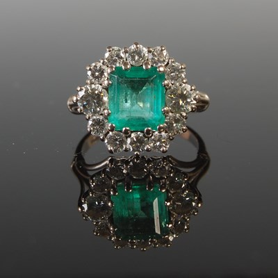 Lot 343 - An 18ct gold emerald and diamond cluster ring,...
