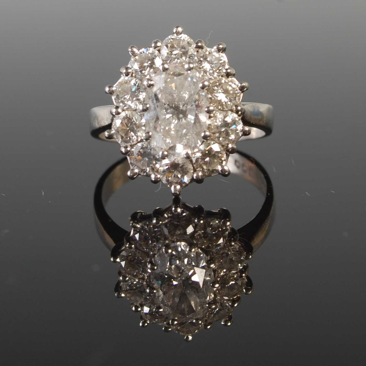 Lot 344 - A platinum and diamond set cluster ring,...