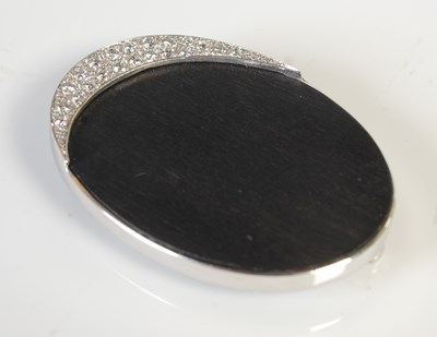 Lot 366 - A white metal ebony and diamond set brooch,...