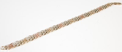 Lot 465 - A three colour yellow metal gatelink bracelet,...
