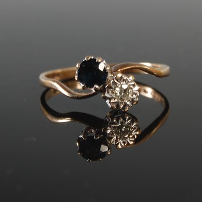 Lot 471 - A 9ct gold sapphire and diamond crossover ring,...