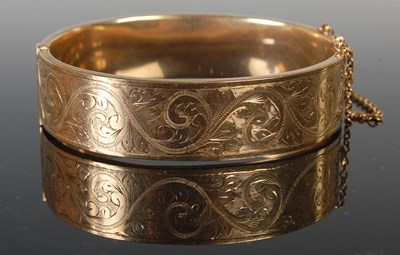 Lot 483 - A 9ct gold hinged bangle, 64.2mm x 56.9mm,...